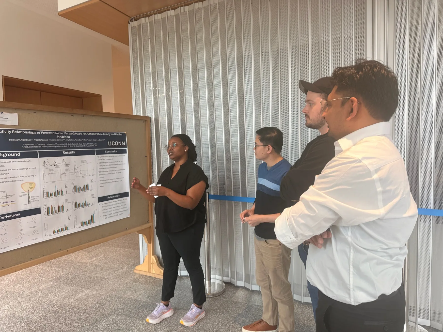 Presenter discussing her poster with industry attendees