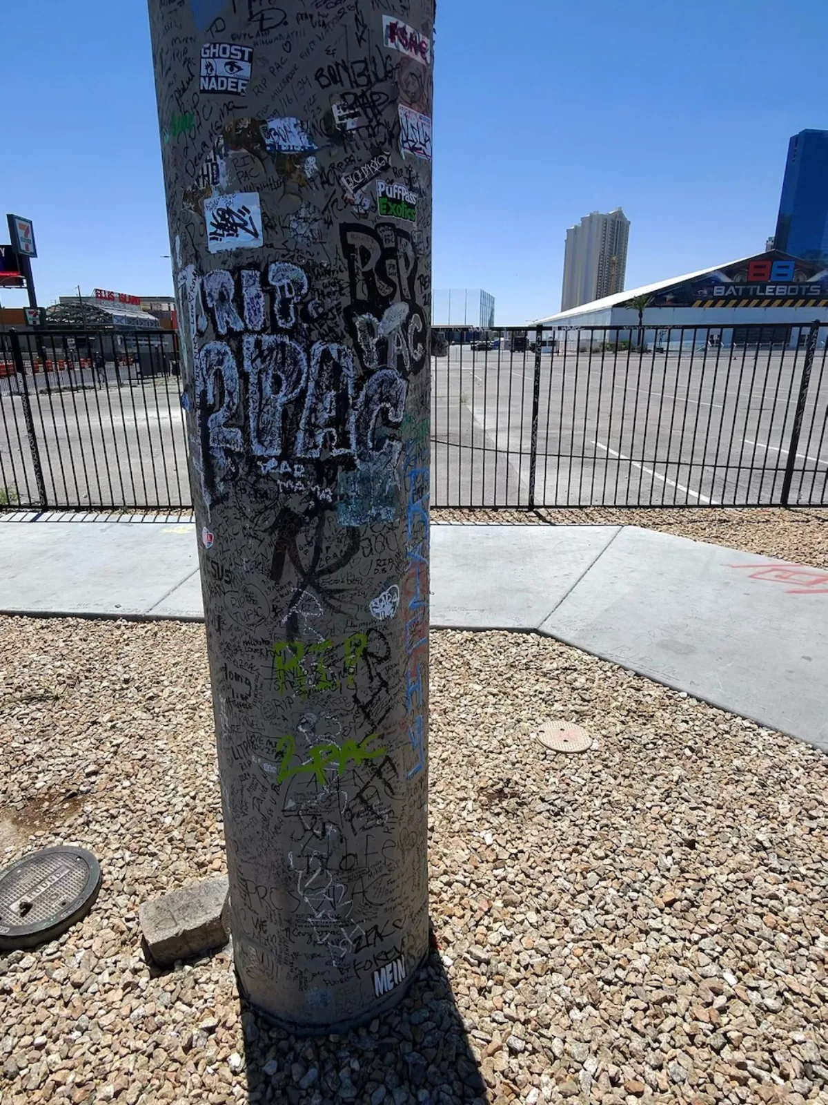 Tupac Shakur memorial site in Las Vegas, a traffic pole covered in RIP 2PAC graffiti and tributes