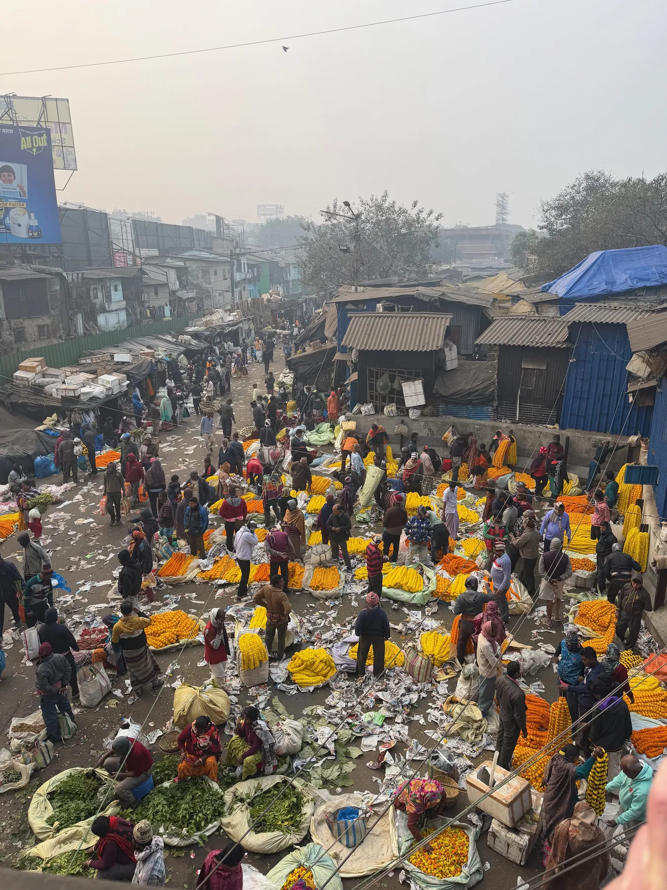 Mallick Ghat flower market from above, heaps of marigolds under the Howrah Bridge approach
