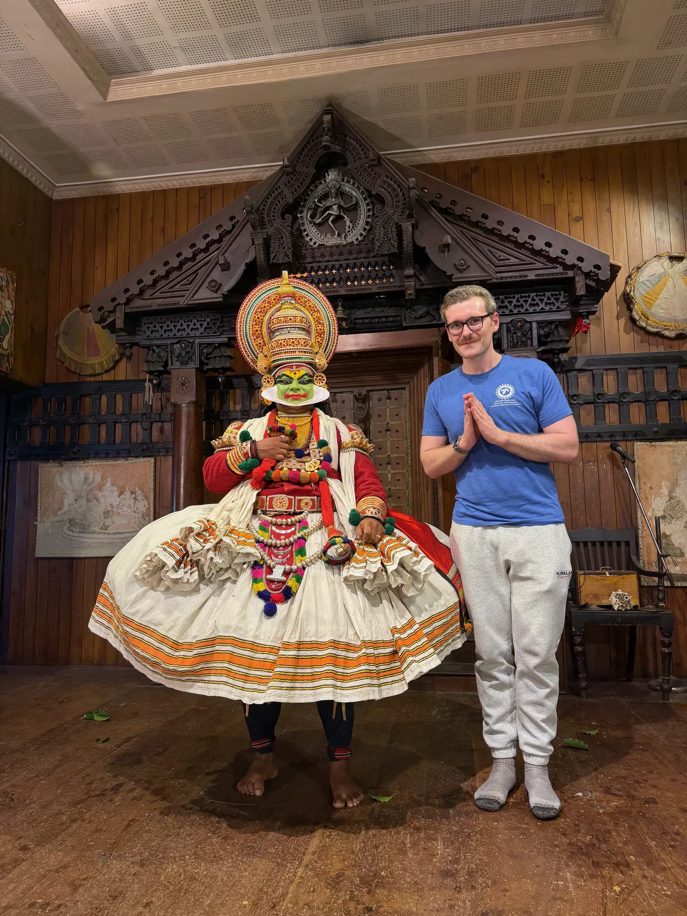 Standing beside a Kathakali performer in full costume and green makeup after a show in Fort Kochi