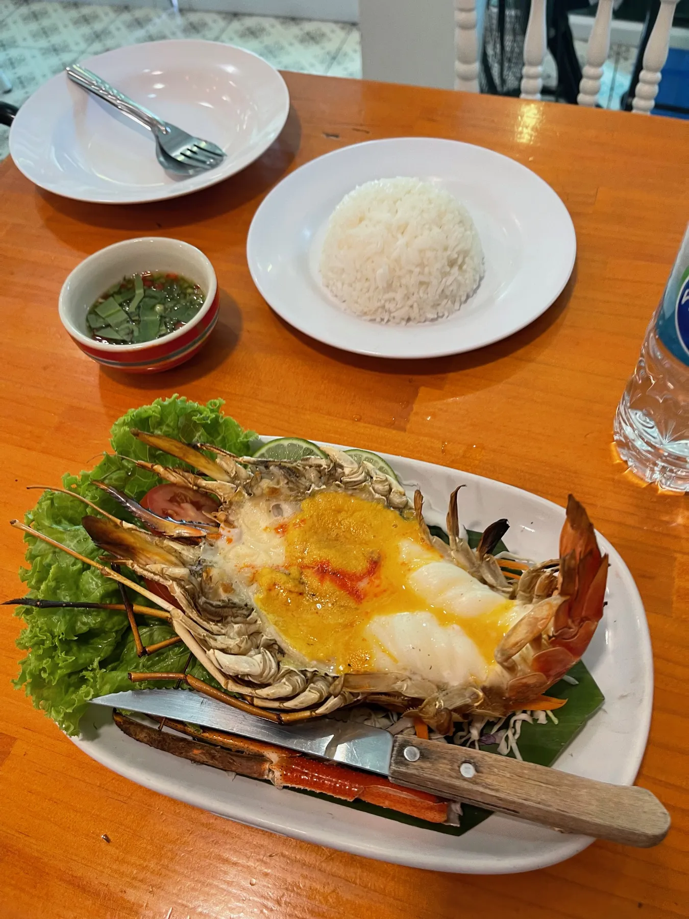 The sea bug: a giant grilled river prawn split open on a bed of lettuce in Ayutthaya