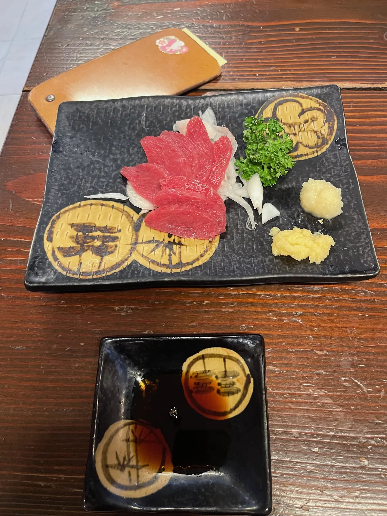 Basashi, thin slices of raw horse meat served with ginger and soy