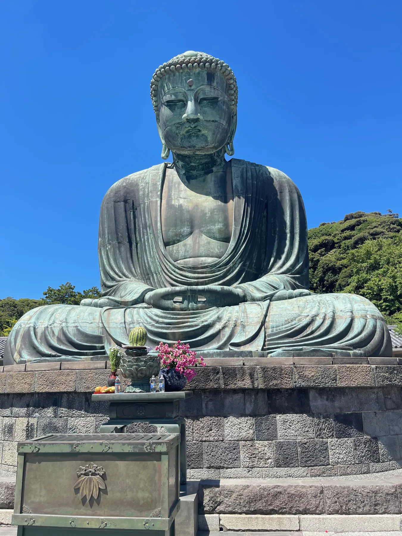 The Great Buddha of Kamakura, a 13-meter bronze statue seated under a clear blue sky